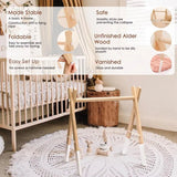 Wooden crib stand in a nursery setting with product features highlighted.