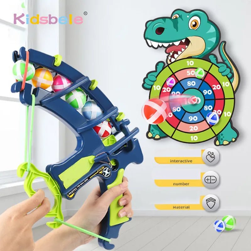 Toy slingshot with colorful balls aimed at a dinosaur-themed dartboard.