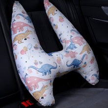 U-Shape Kids Travel Pillow with dinosaur design fitted in a car seat for comfortable head support on trips.