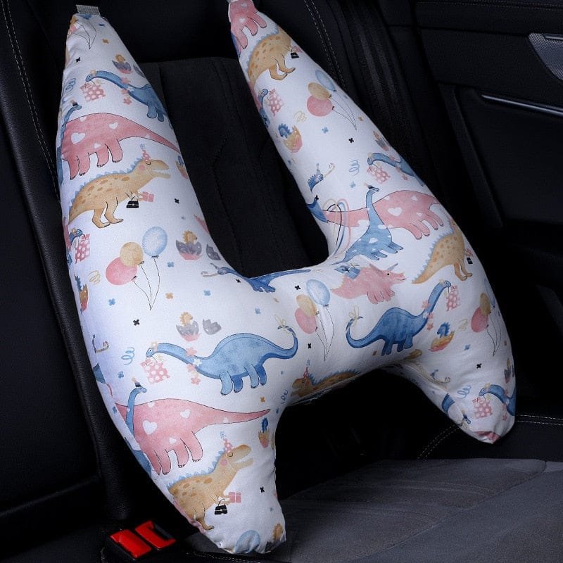 U-Shape Kids Travel Pillow with dinosaur design fitted in a car seat for comfortable head support on trips.