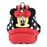 Backpack with Minnie Mouse design featuring a red bow and black polka dot pattern.