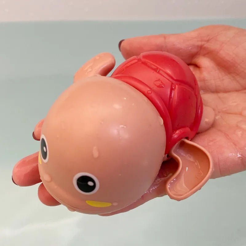 Duck and Penguin Egg Water Spray Bath Toy red octopus design held for interactive bath fun.