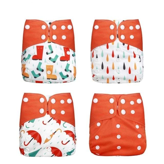 Four colorful cloth diapers with orange polka dot closures 