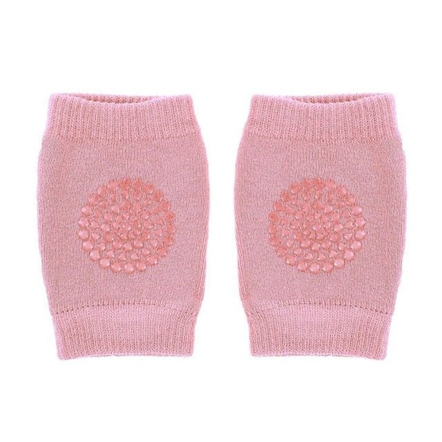 Pair of pink knitted baby leg warmers with a textured design.