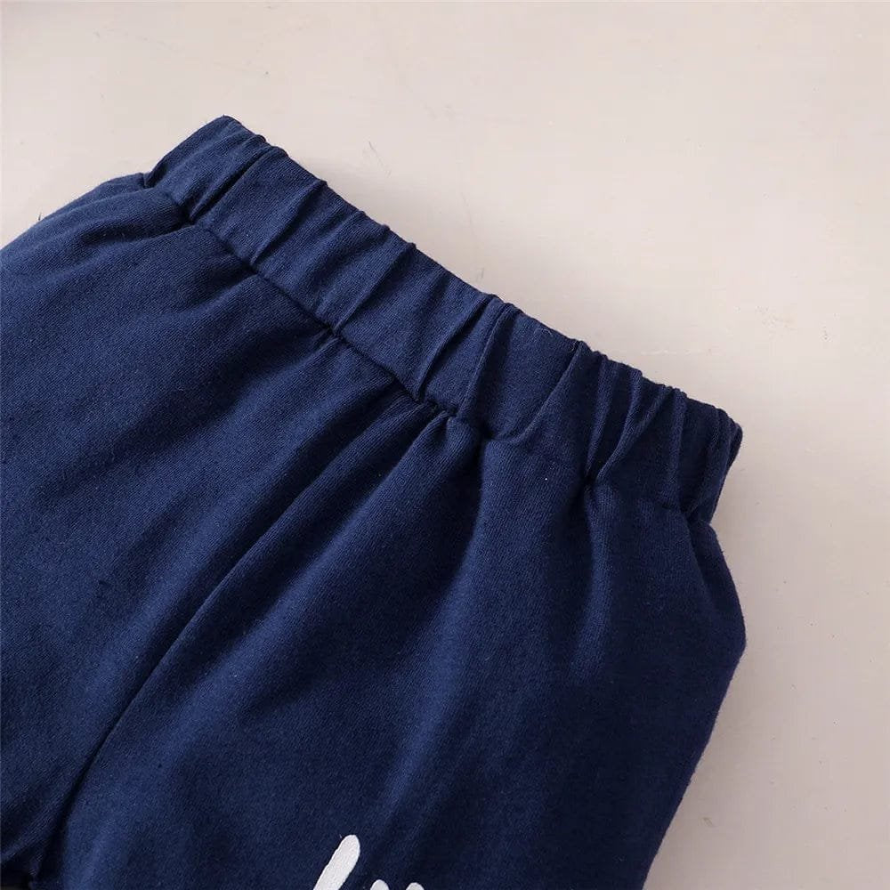 Navy blue sweatpants with a brand logo on a light gray background