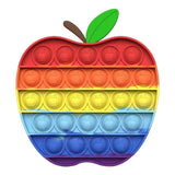 Colorful pop-it toy shaped like an apple with a green leaf on a white background