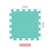 Green foam puzzle mat with dimensions on a white background