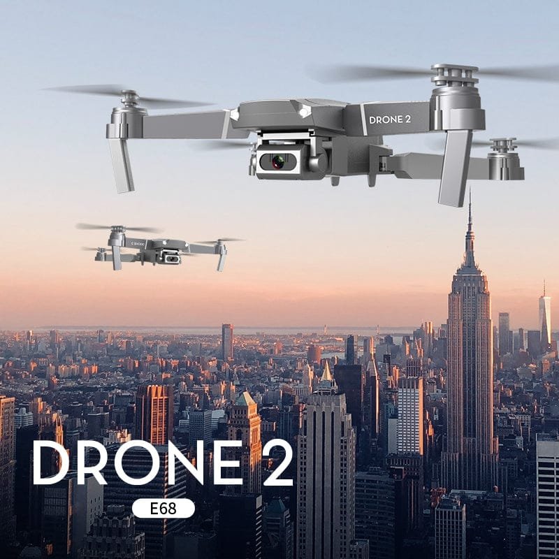 E68 mini drone flying over a city skyline for urban aerial video, travel vlogging, and rooftop photography.