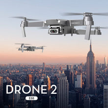E68 mini drone flying over a city skyline for urban aerial video, travel vlogging, and rooftop photography.