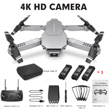 E68 mini drone with folded arms beside its accessories for compact storage in a backpack or car boot.