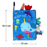 Children's soft book with ocean-themed illustrations and toys, showing dimensions.