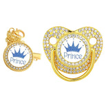 Gold pacifier with 'Prince' and crown design on a white background