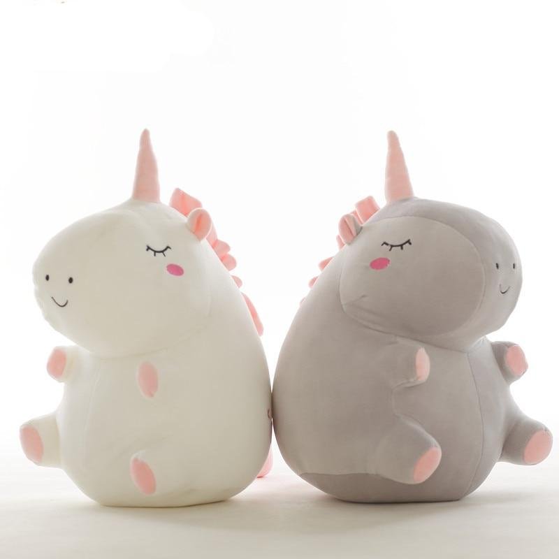 Two plush toys resembling unicorns on a white background.