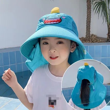 Child wearing a blue bucket hat with a cartoon character, standing by a pool.