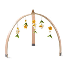 Wooden baby play gym with floral hanging toys for gentle early learning play and nursery decoration.