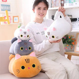 Woman holding a stack of cat-shaped cushions in a cozy living room.
