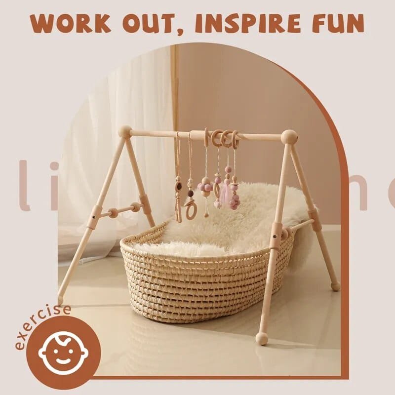 Baby play gym with hanging toys on a soft surface, text 'Work Out, Inspire Fun' above.