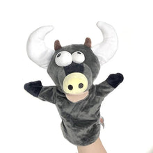 Plush bull puppet with a hand holding it.