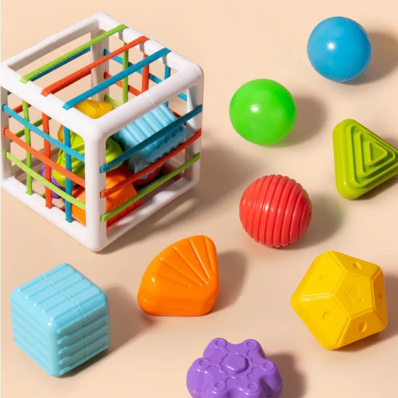 Colorful toy cube with various shapes and balls.