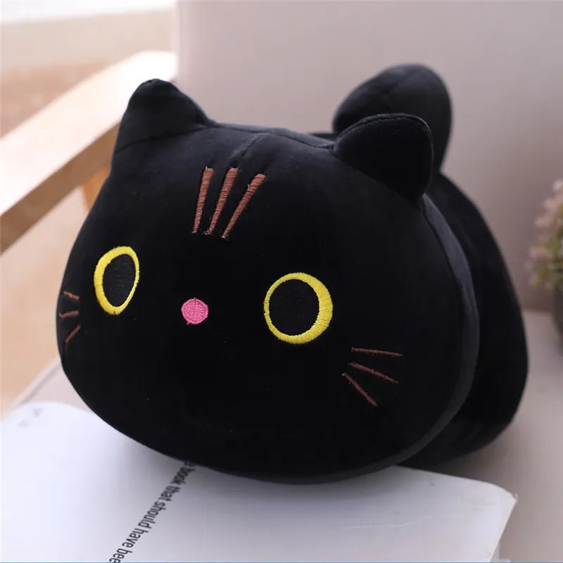 Black cat-shaped plush toy on a surface with a light background