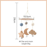 Wooden mobile with stars, moon, and balls with measurements on a white background