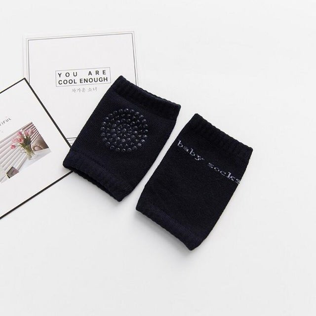 Elastic black baby safety knee pads with stretch cuffs that stay in place through long crawling sessions.