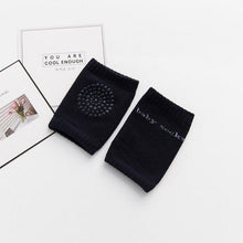 Elastic black baby safety knee pads with stretch cuffs that stay in place through long crawling sessions.