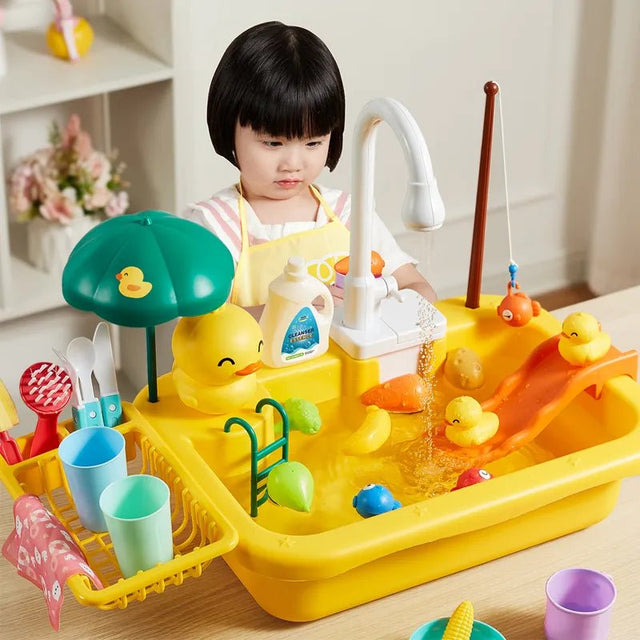 Child playing with a colorful toy bathtub set on a wooden floor.