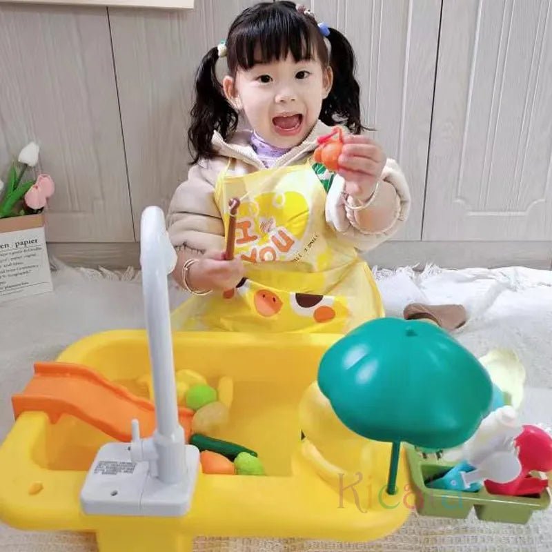 Child playing with a toy kitchen set in a room with a white cabinet.