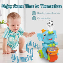 Baby reaching toward a blue elephant drummer toy with a floating ball