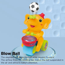 Yellow elephant drummer toy blowing a floating ball in the air