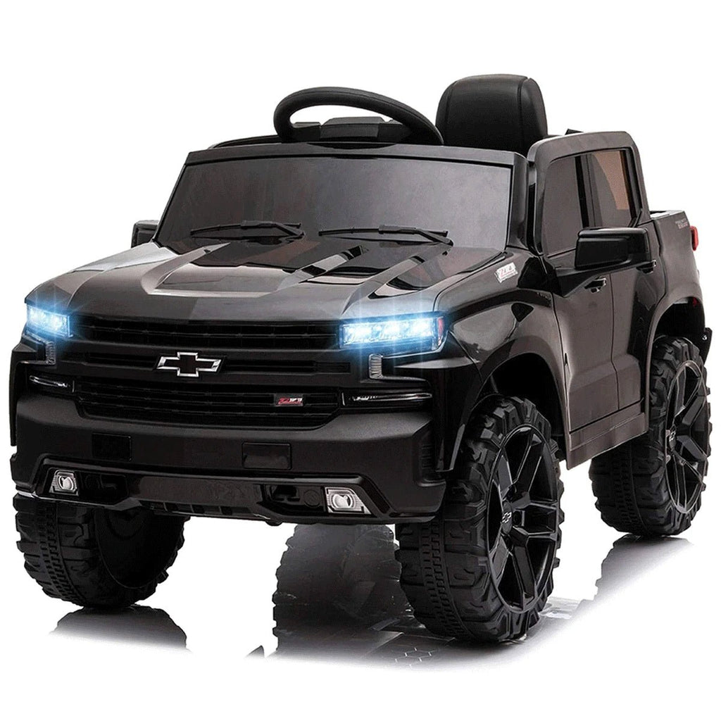 Black toy truck with glowing headlights.