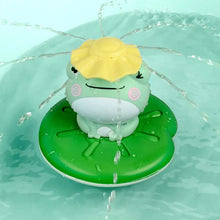 Electric spray water frog bath toy with a yellow shell floating on a lily pad in the tub.