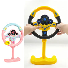 Pink steering wheel toy on a stand beside a yellow one held by two hands