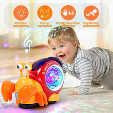 Electronic crawling crab glowing music toy used by a child for interactive floor play.