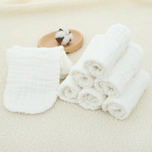 Elinfant cotton diaper inserts laid on a beige surface for daily cloth diapering use.