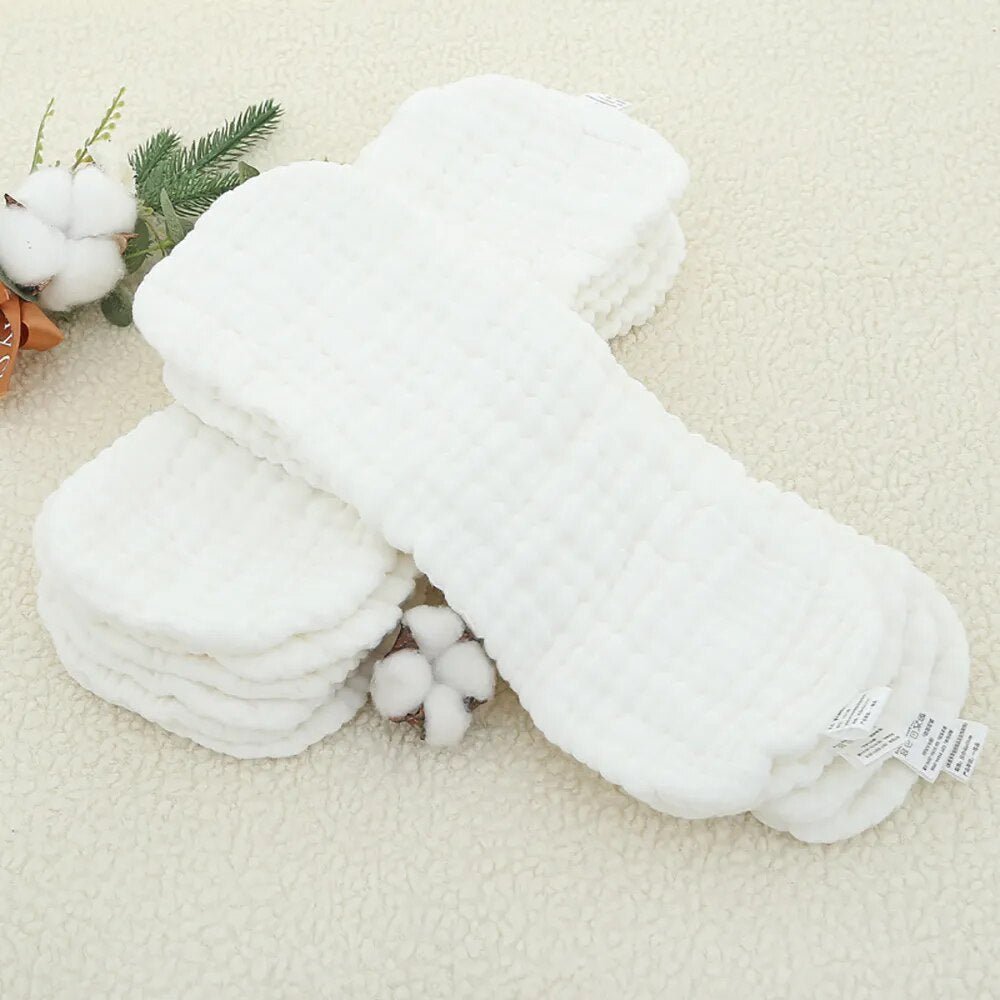 Stacked Elinfant cotton diaper inserts showing absorbent layers for reusable cloth diapering.