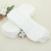 Stacked Elinfant cotton diaper inserts showing absorbent layers for reusable cloth diapering.