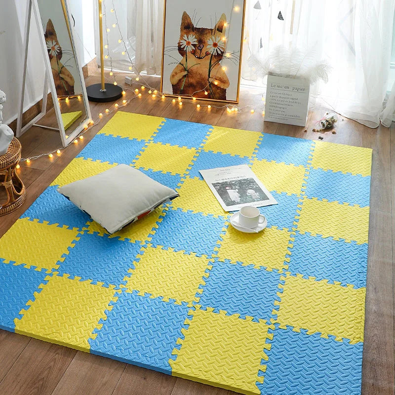Yellow and blue interlocking foam mats on a wooden floor with decorative elements.