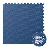 Blue textured foam puzzle mat with a diamond pattern on a white background