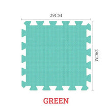 Green foam puzzle mat with dimensions on a white background