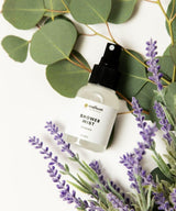 Shower mist bottle with lavender and eucalyptus leaves.