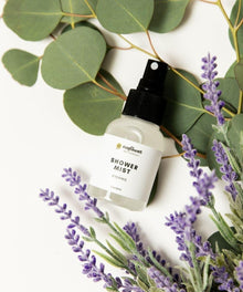 Shower mist bottle with lavender and eucalyptus leaves.