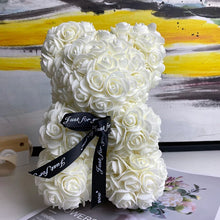 White rose teddy bear with a black ribbon.