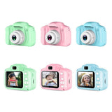 Set of colorful children's cameras with screens displaying photos on a white background