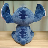 Blue plush toy with a distinctive logo on a wooden surface