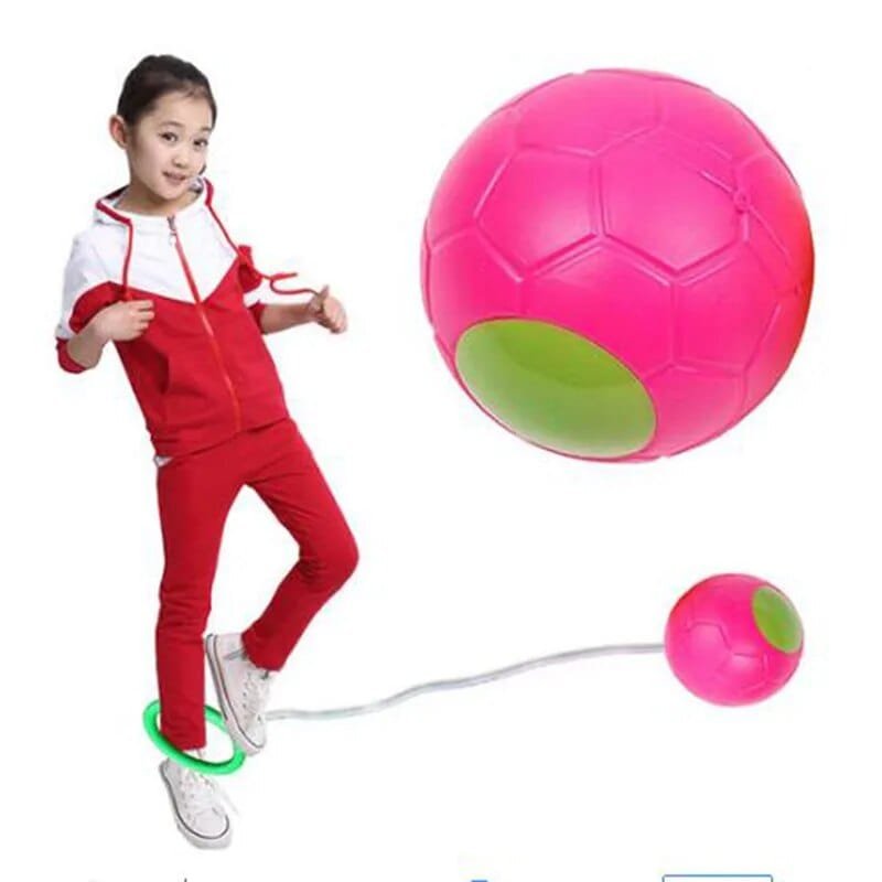 Child in red outfit with a pink and green ball on a white background