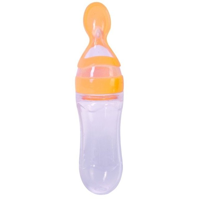 Baby bottle with orange cap on a white background