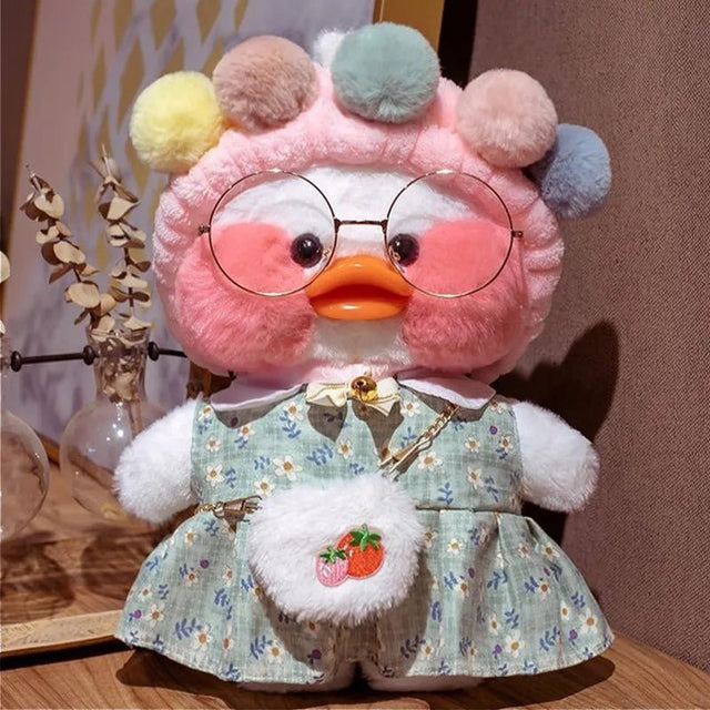 Plush toy with a floral dress and round glasses on a wooden surface.