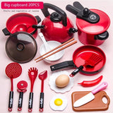 Set of red kitchen utensils and cookware on a pink background